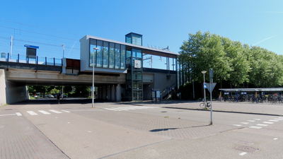 912842 Gezicht op het verhoogde NS-station Vleuten van bij de Oesterzwam, met rechts een fietsenstalling en links de ...